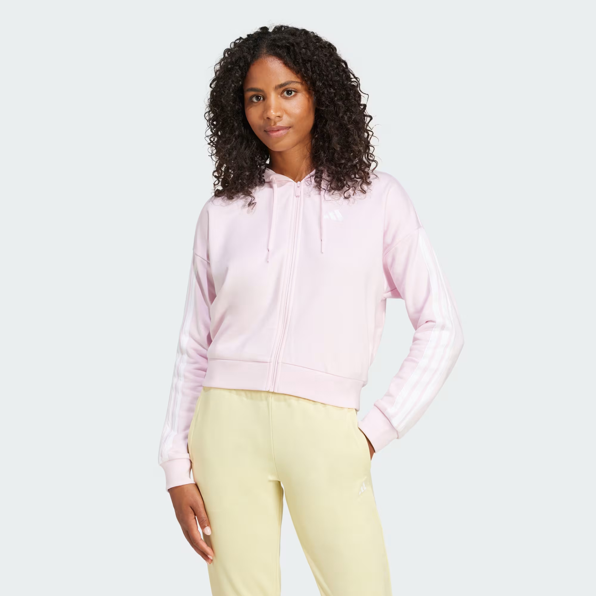 women in pink adidas hoodie and yellow trousers
