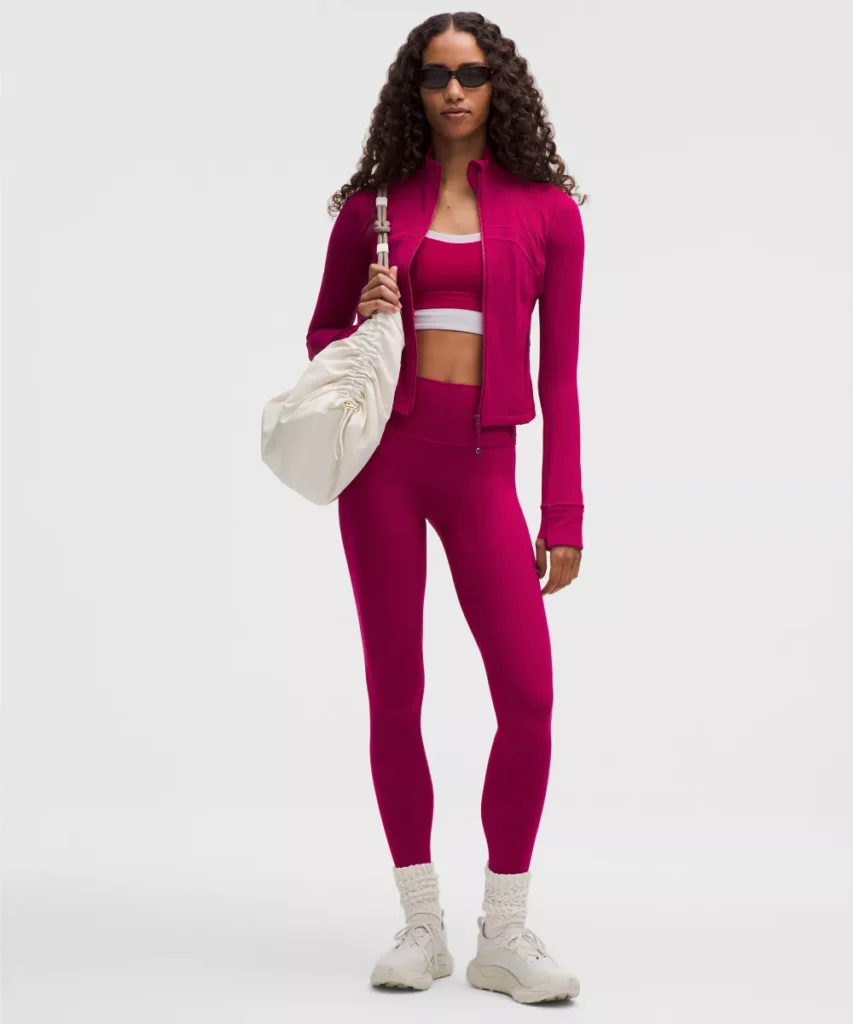 woman in pink fuschia workout clothes jacket and bag