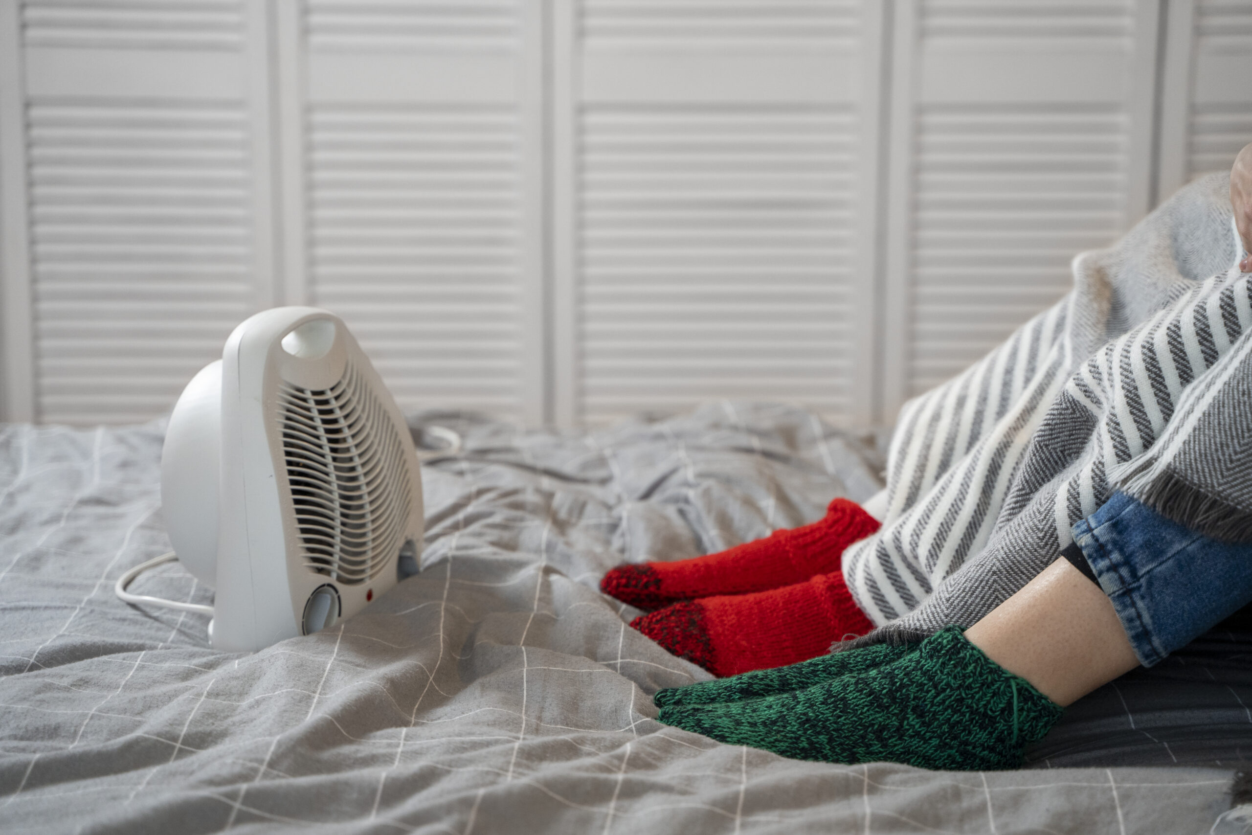Couple with a heater on their bed