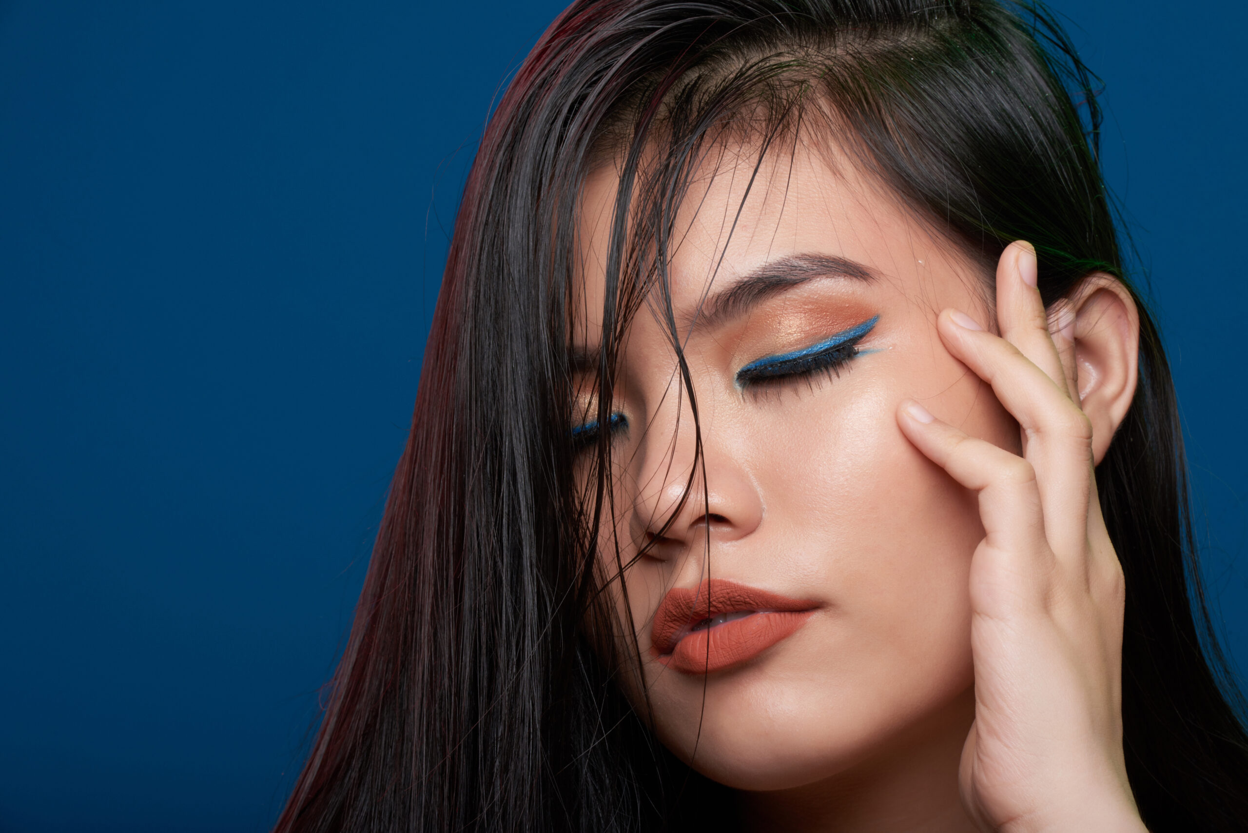 Woman with blue winged eyeliner