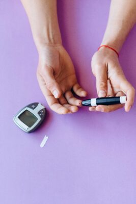 Woman checking blood sugar level