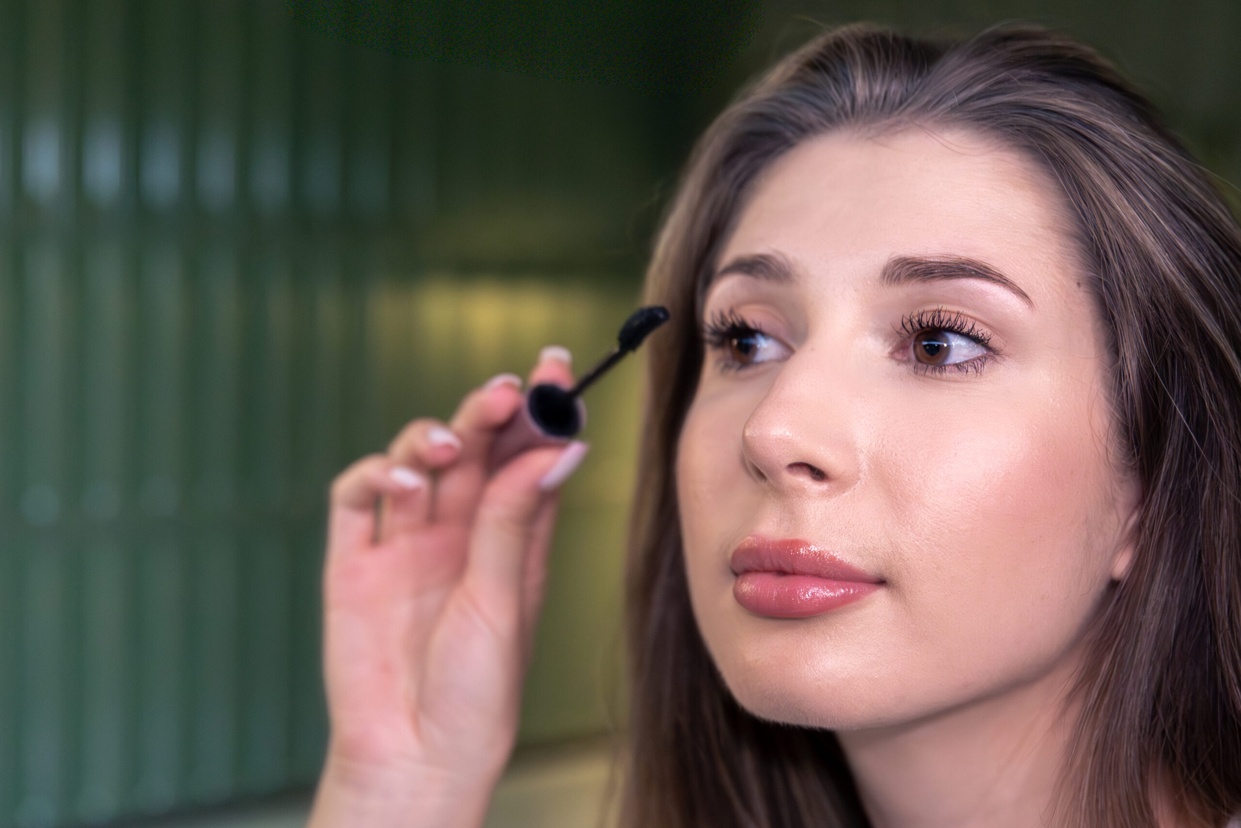 Woman applying mascara