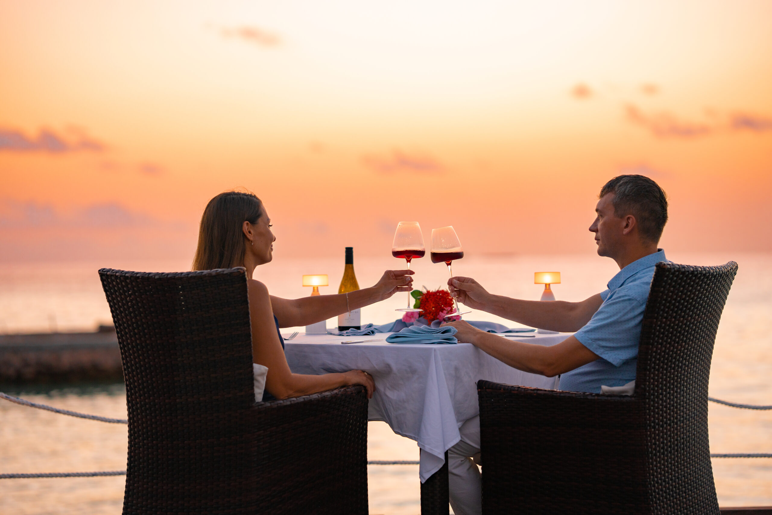 Couple enjoying a sunset beach dinner