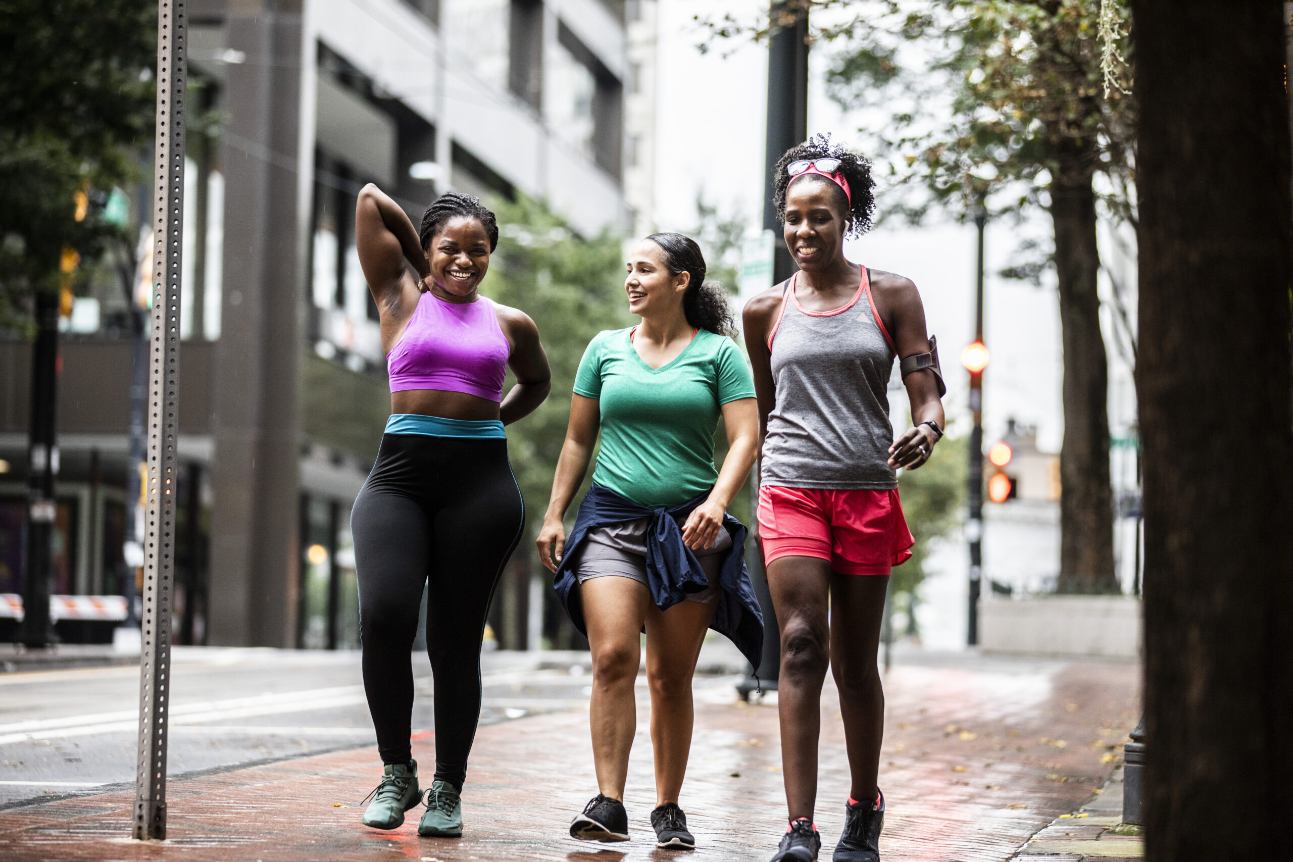 Group of women running through urban area