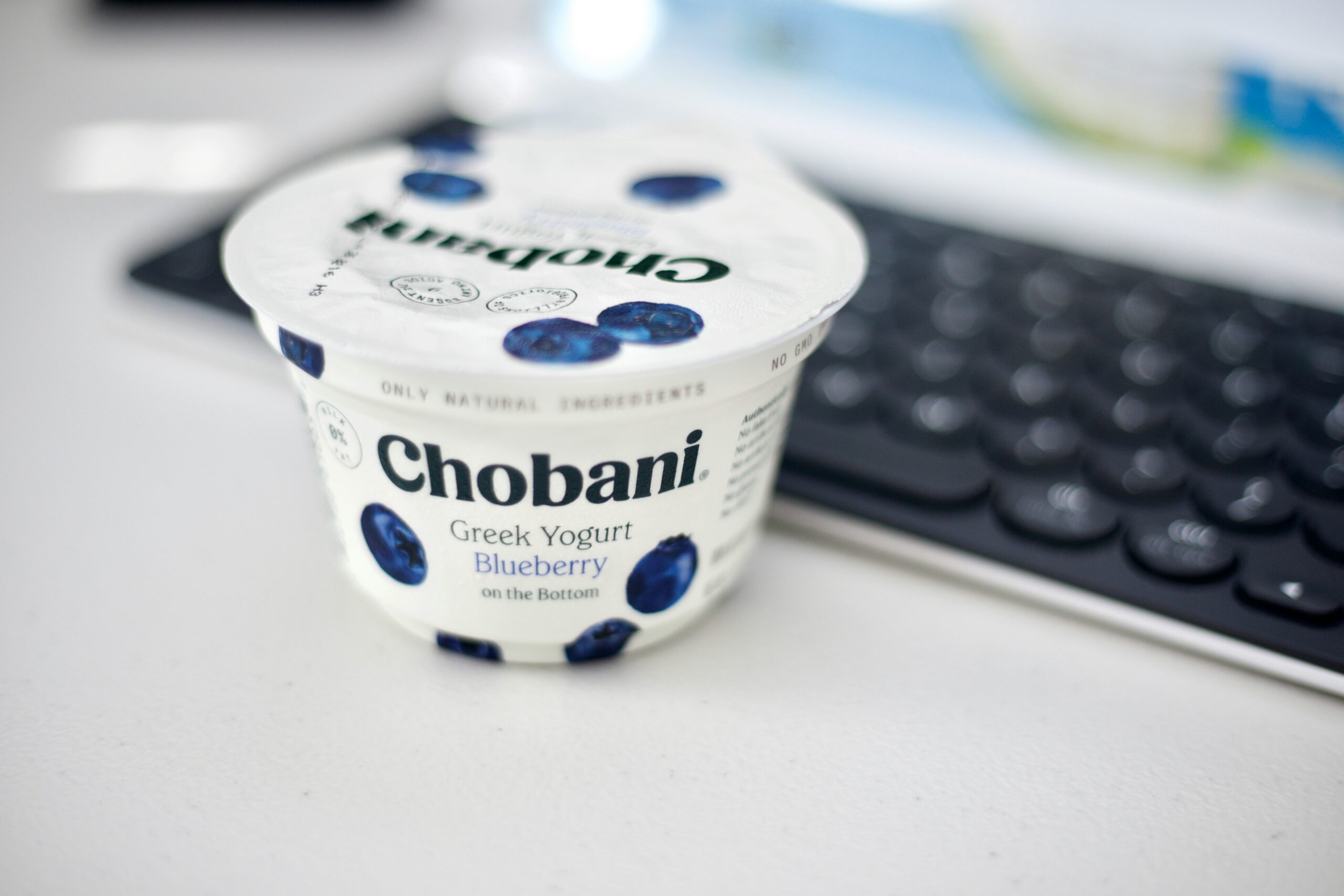 keyboard with yoghurt and blueberry pot