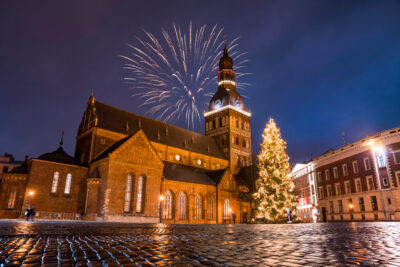 A church in Salzburg with a Christmas tree and fireworks