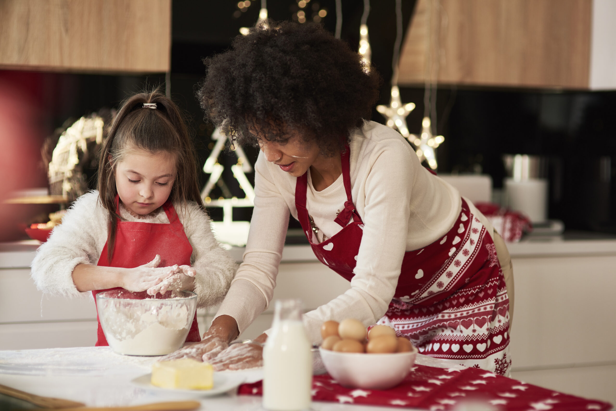 Mother and daughter baking together