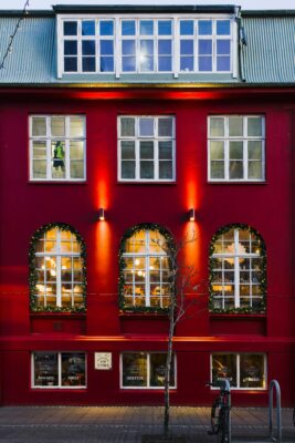  Reykjavík, Iceland at Christmas. A red storefront with fairylights 