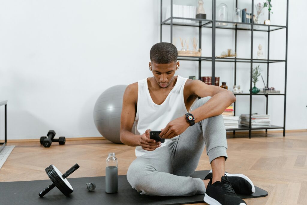 A man checks his phone after working out