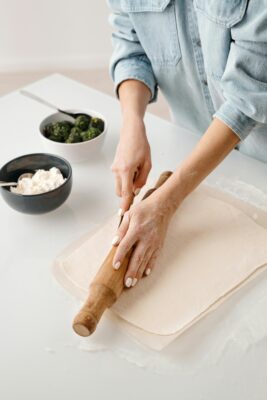 women rolling out pre-made pastry