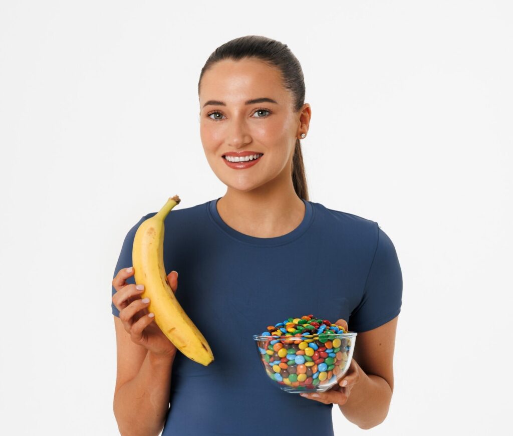 Georgia Heins poses with a banana and a bowl of M&Ms