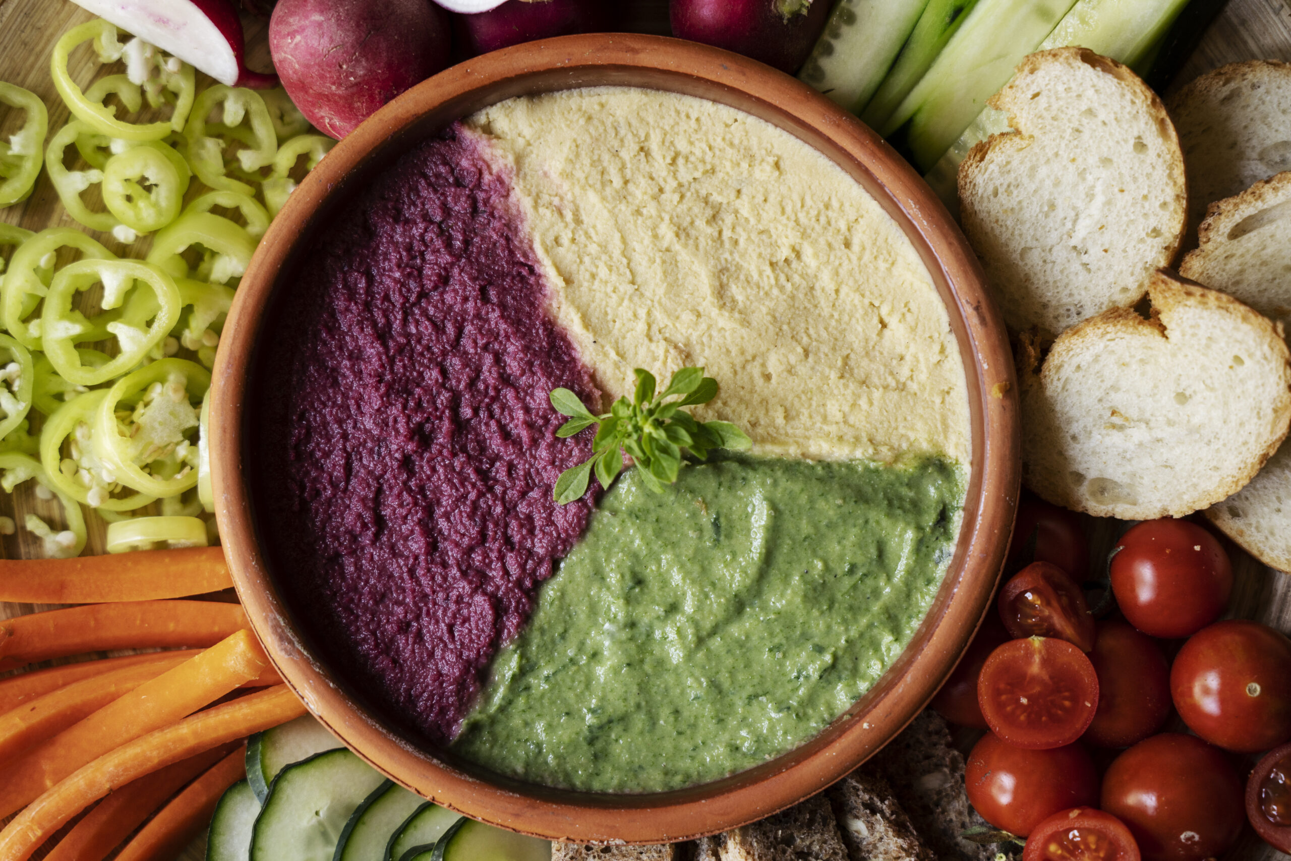 Hummus dip bowl with vegetables and bread