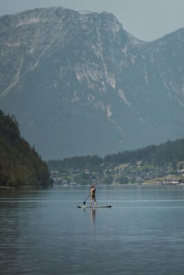 Woman paddleboarding on large body of water