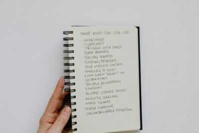A notebook with ADHD symptoms written iut