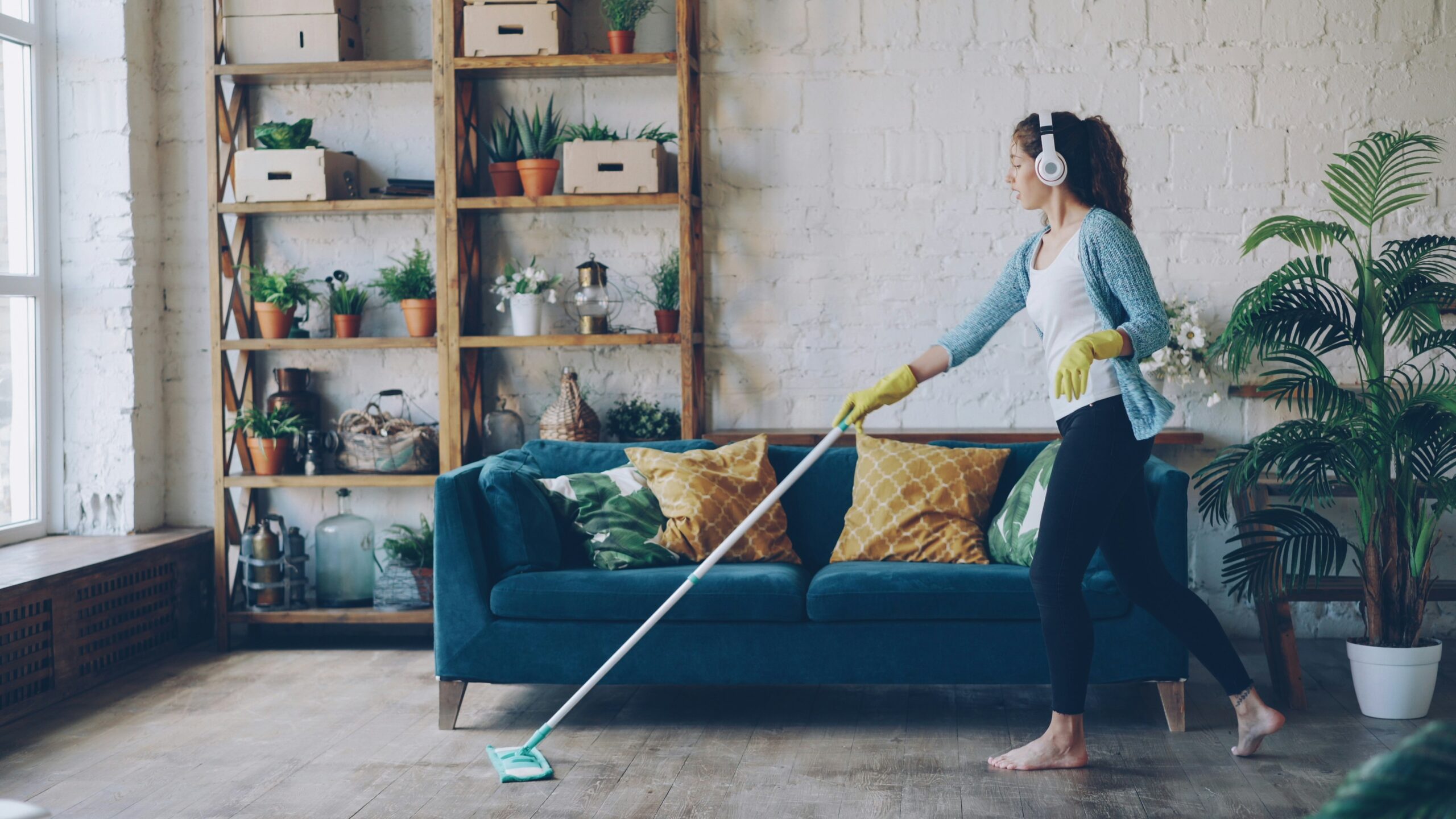 woman cleaning with headphones in