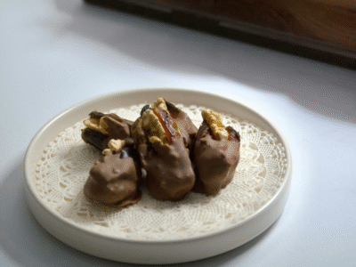 A dish of chocolate coated nut-stuffed dates