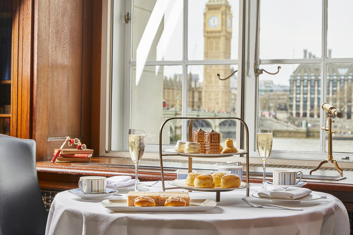 table with double tiered stand and scones looking out to Thames