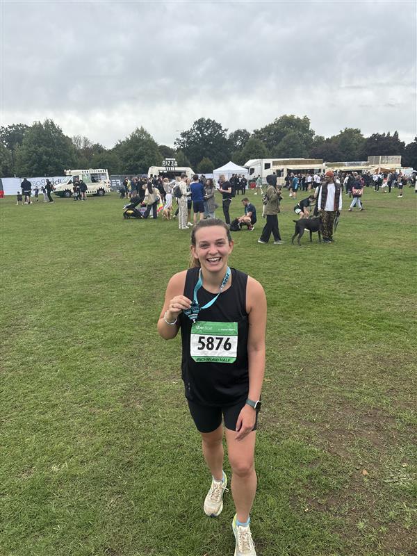 Evelyn Richards holds a medal after a half marathon