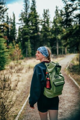 a woman hiking outdoors with a backpack