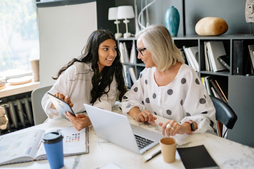 Two women chatting over a laptop 