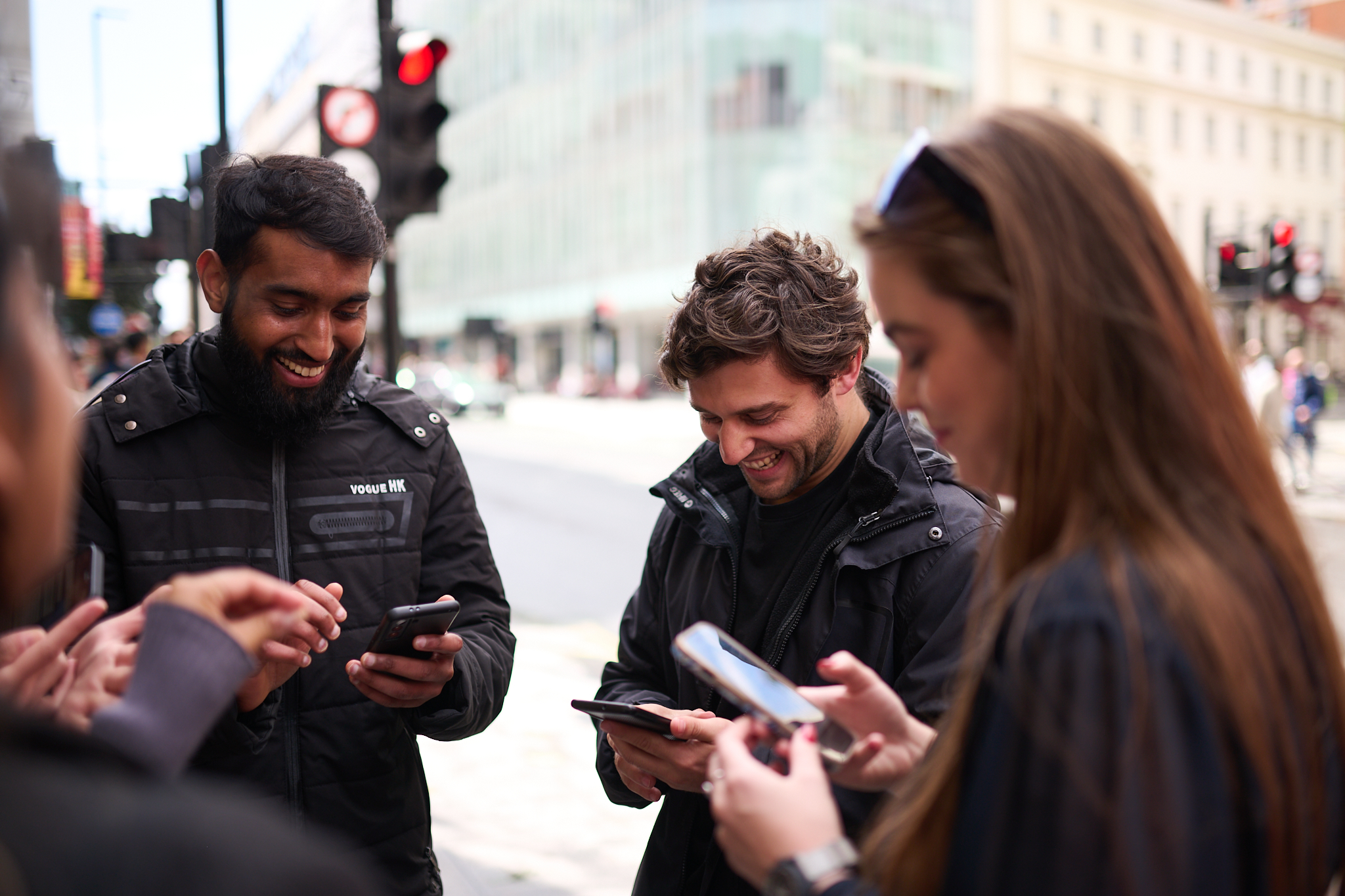 people doing StreetHunt standing in street looking at phones solving mystery in London