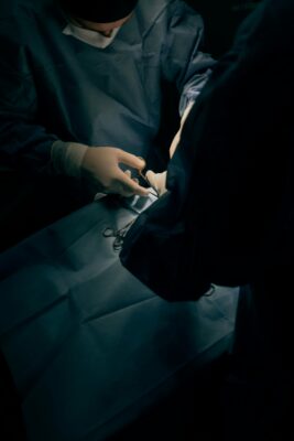Surgeons using tools on a patient during a surgery