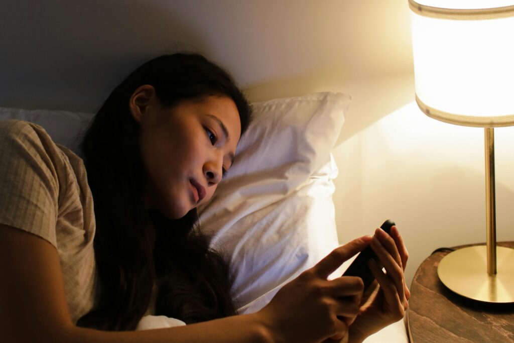 Woman on her phone in bed