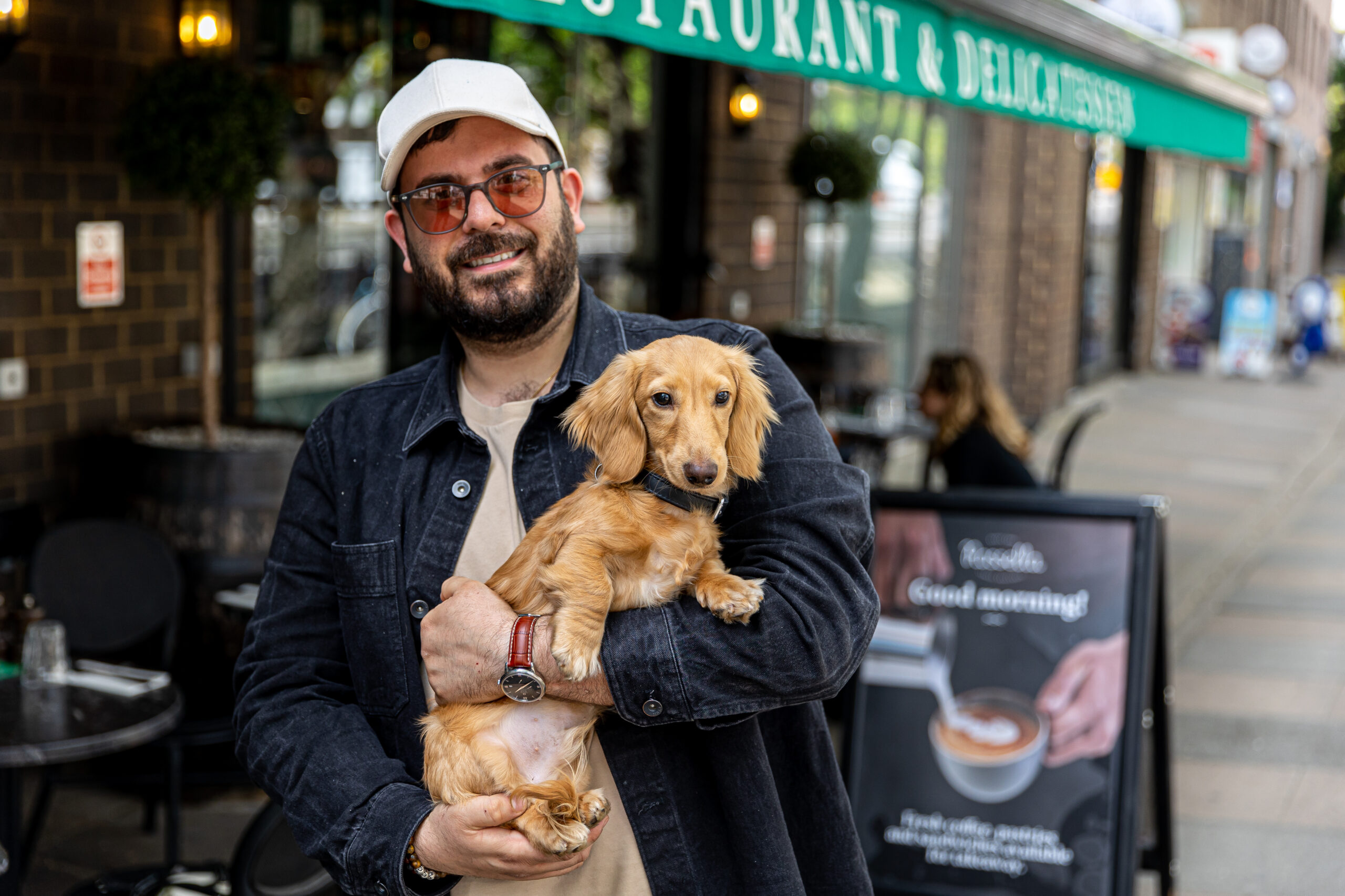 Rossella restaurant founder with his dog outside the dog friendly restaurant in Kentish Town
