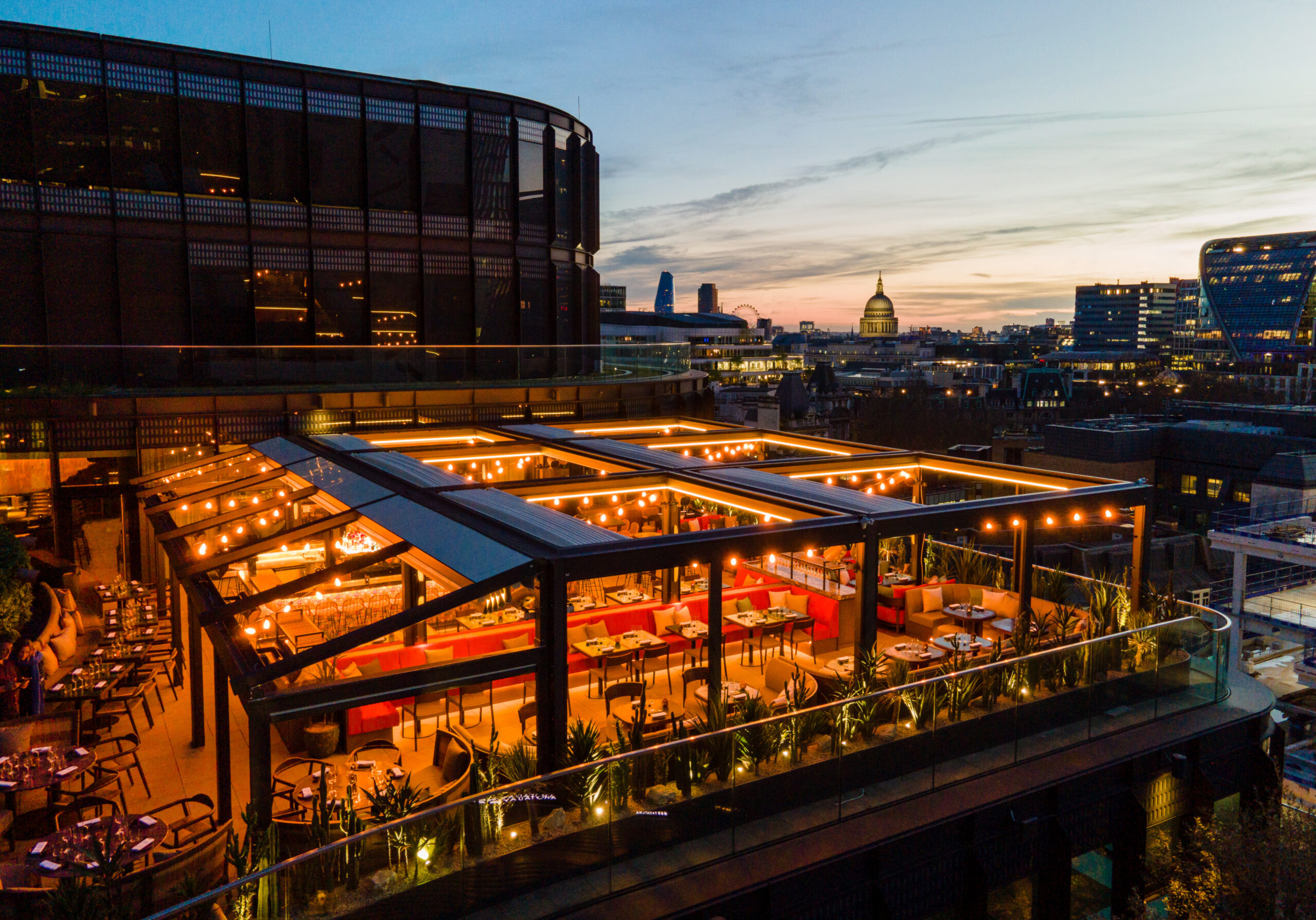 dog-friendly rooftop of Los Mochis restaurant in front of London skyline at sunset