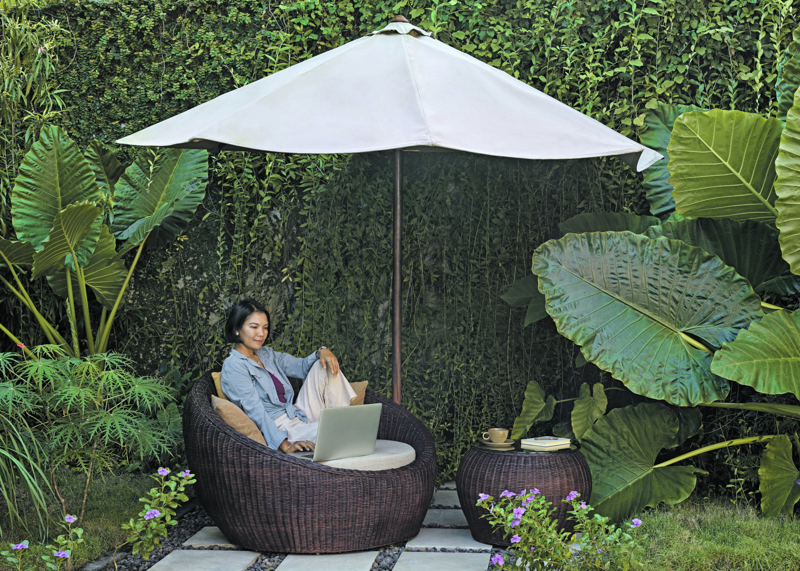 Woman sitting on garden furniture