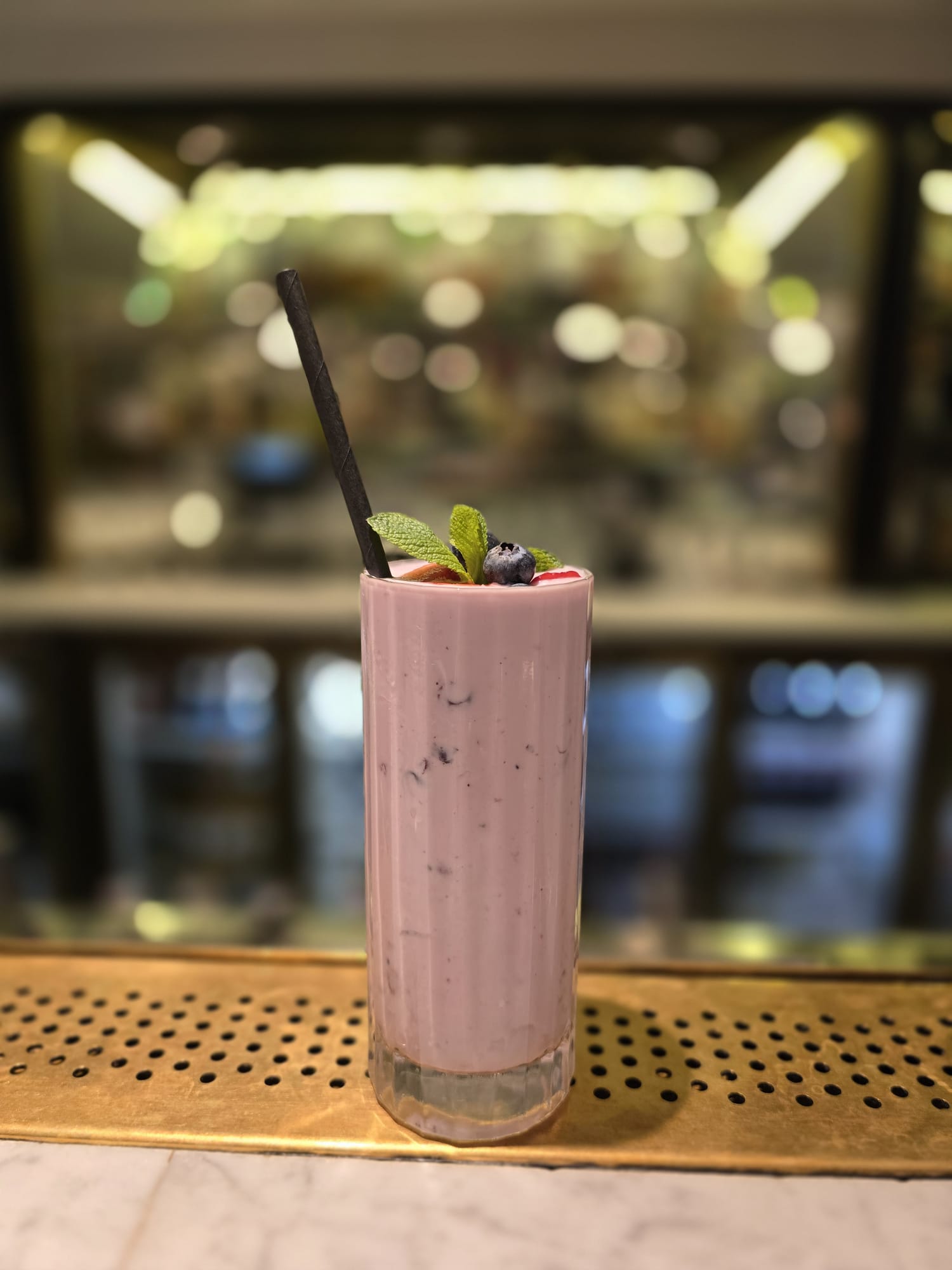 pink smoothie on the edge of a bar