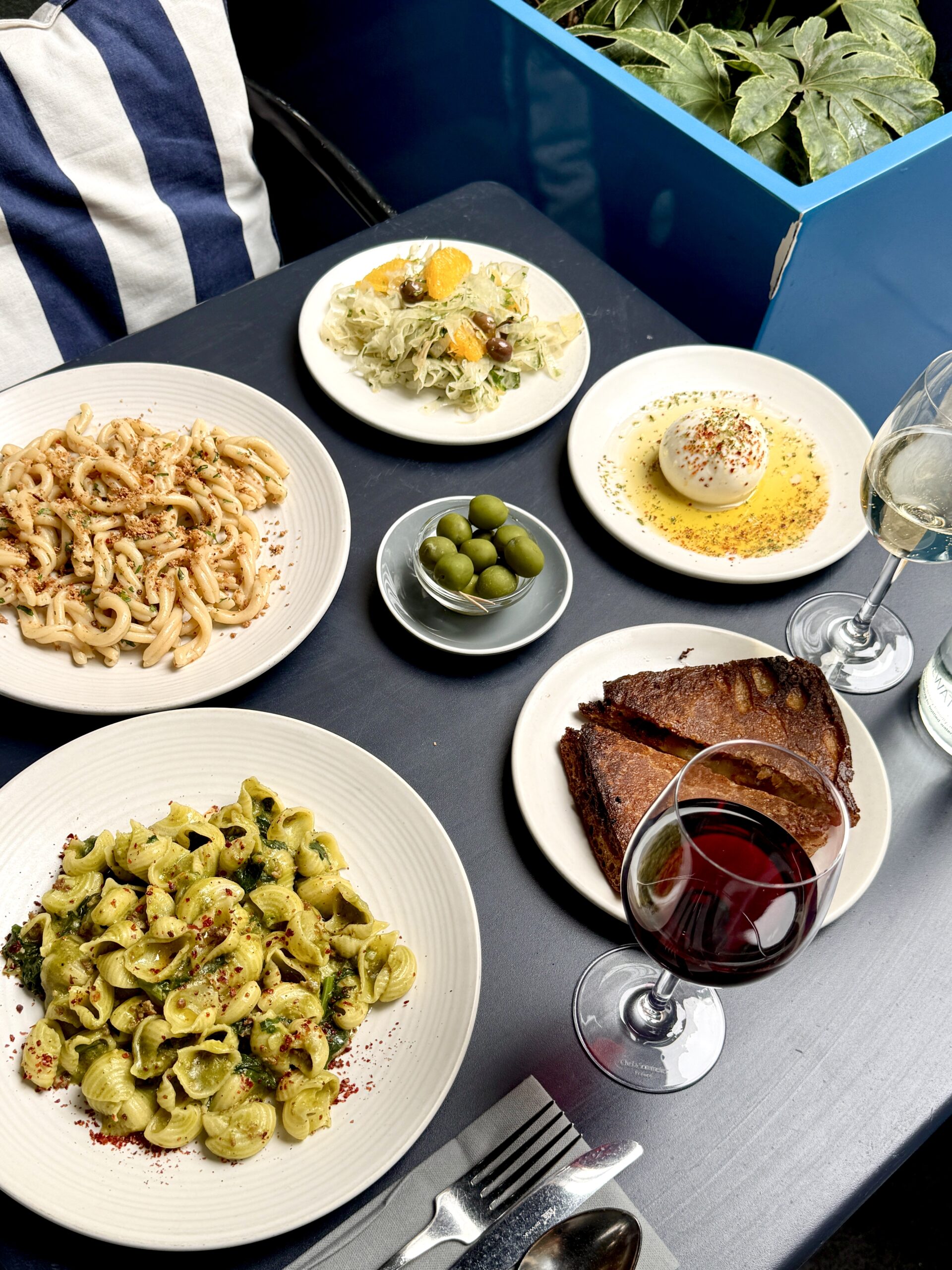 Pasta dishes on a table from Pastaio with wine 