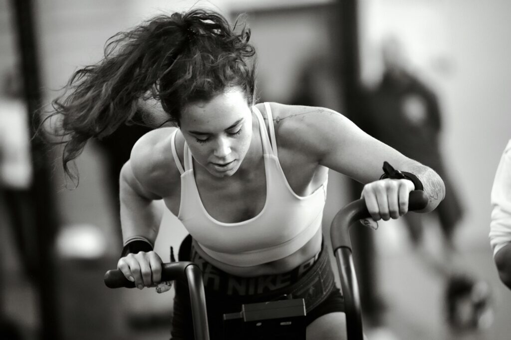 Woman in sportswear training on machine