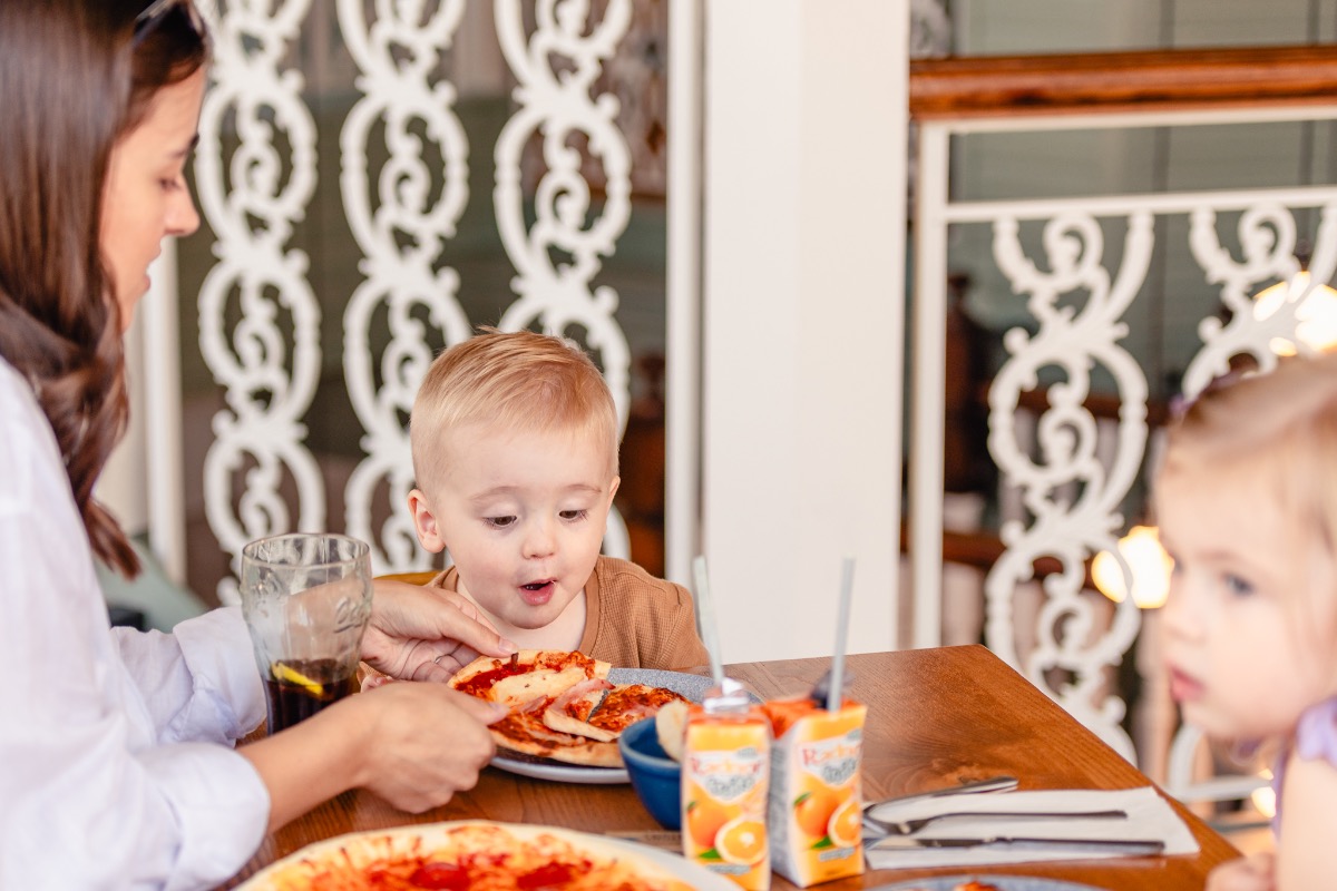 Mother with her children eating pizza