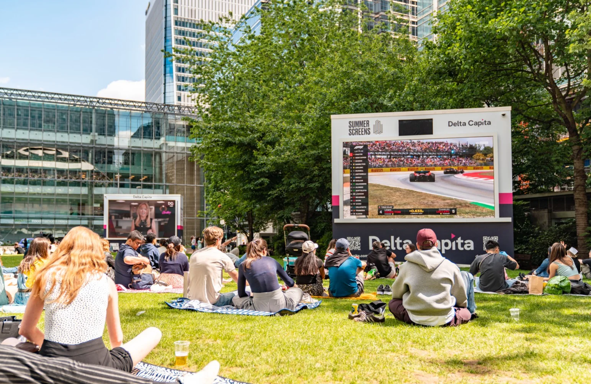 People sitting at Canary Wharf Summer Sc