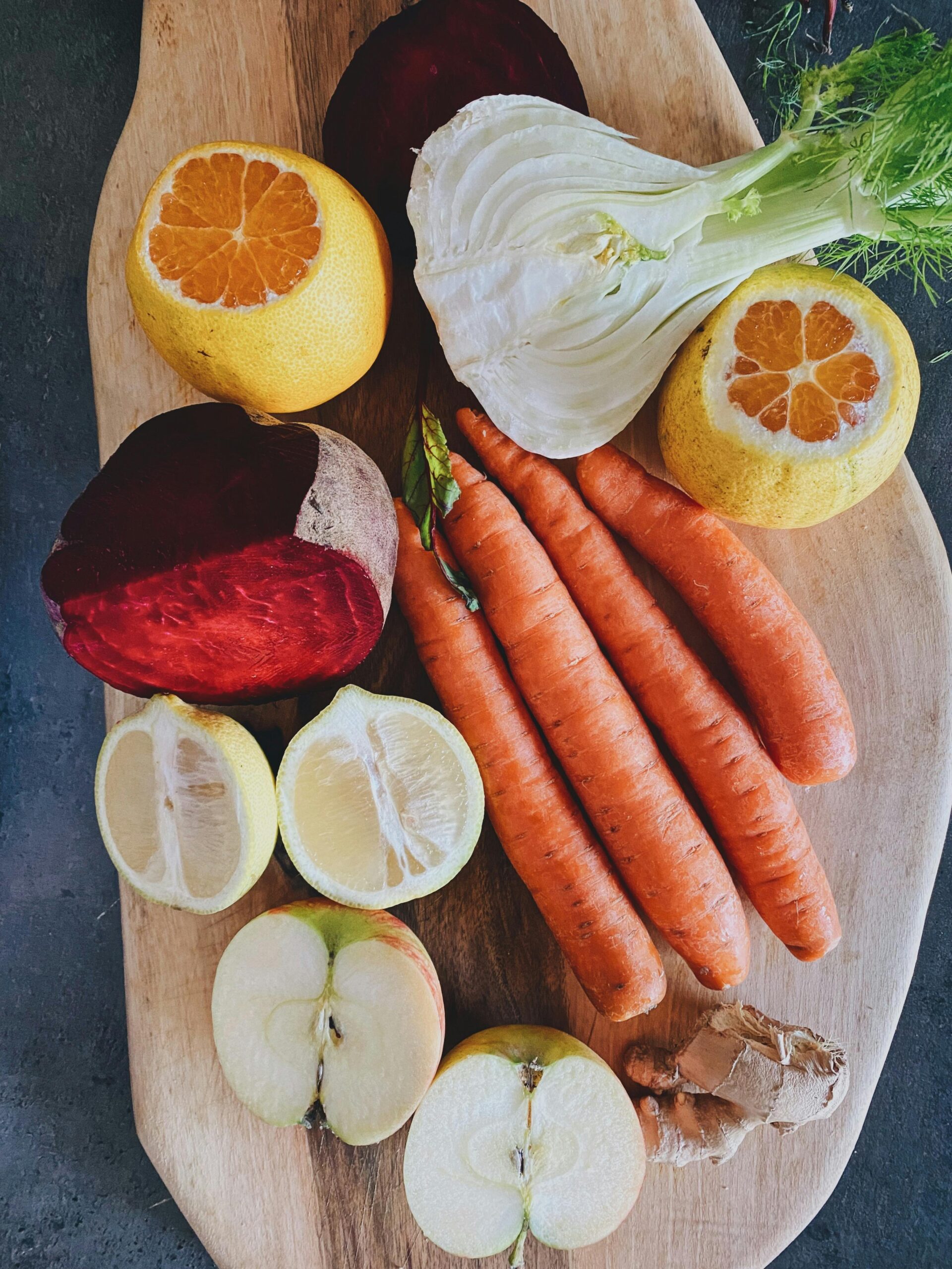 carrots lemons apples ginger on a plate