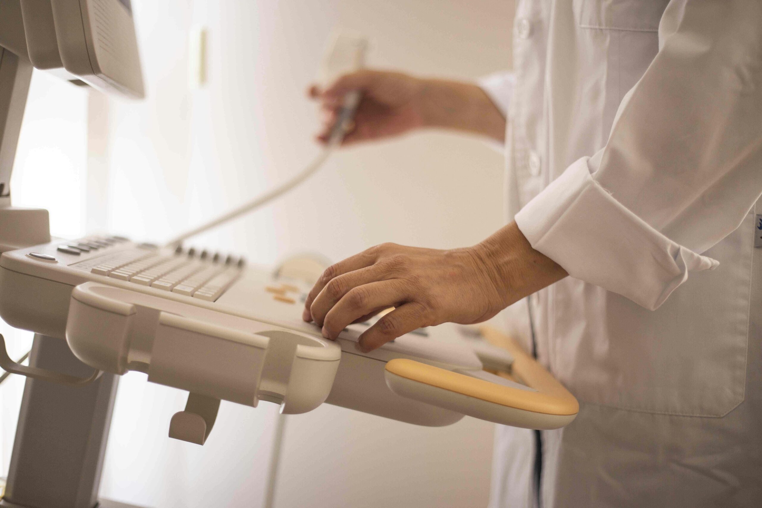 doctor at the edge of an ultrasound machine