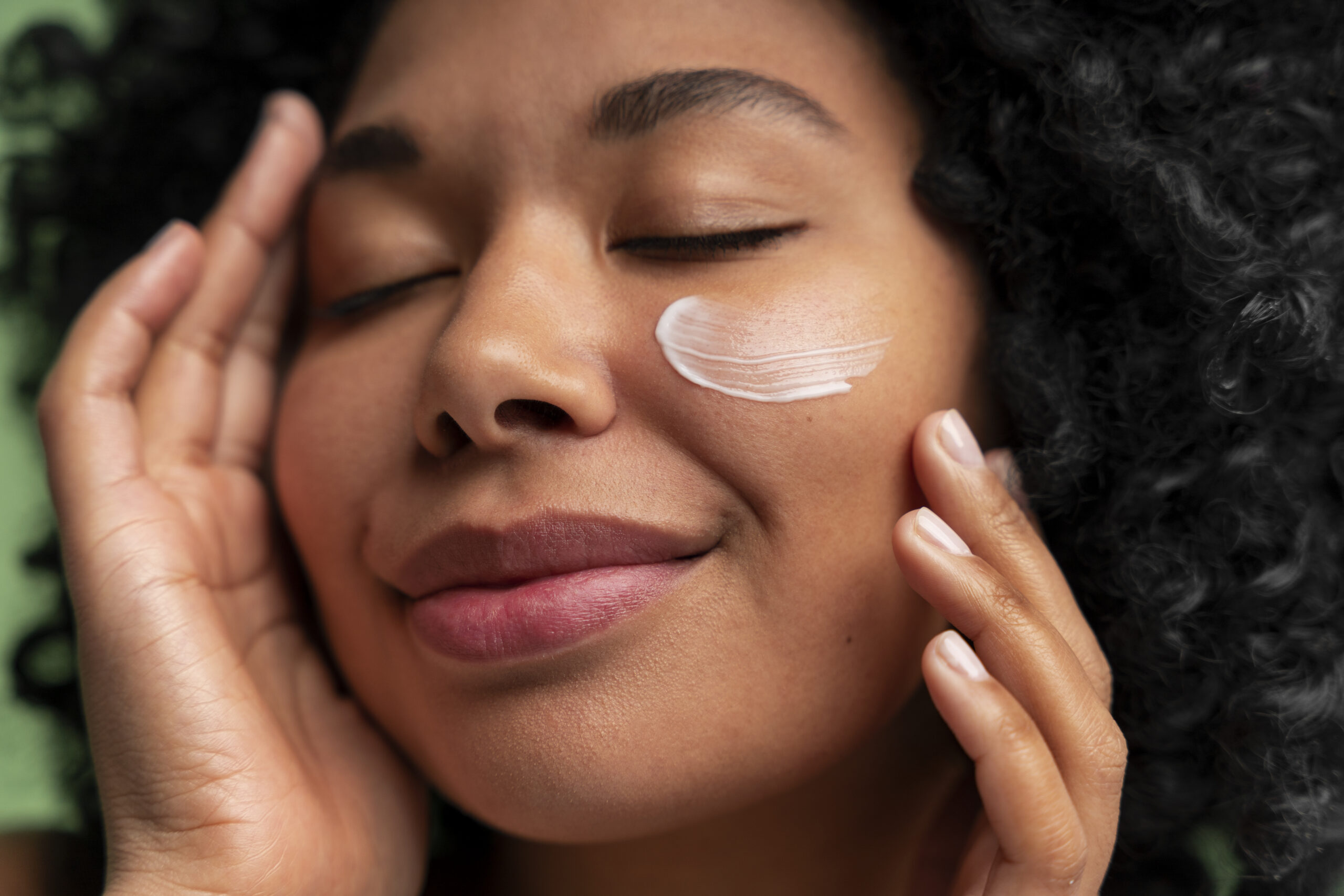 Woman applies sunscreen