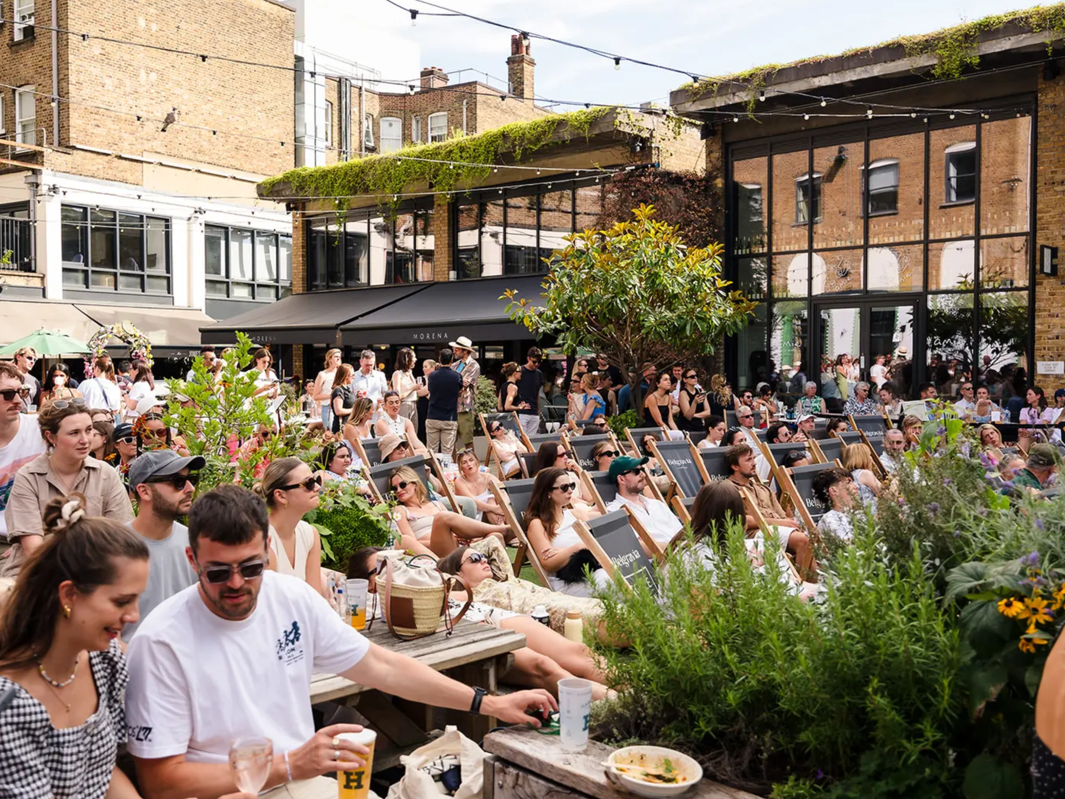 Fans watch Wimbledon in Ecclestone Yards