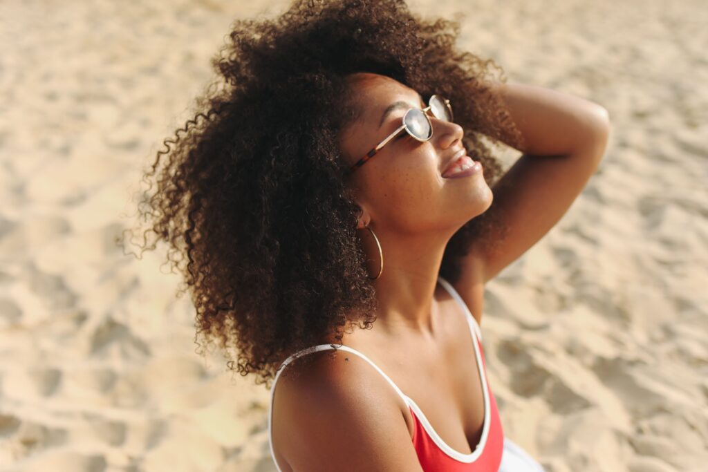 Woman on the beach wearing sunglasses
