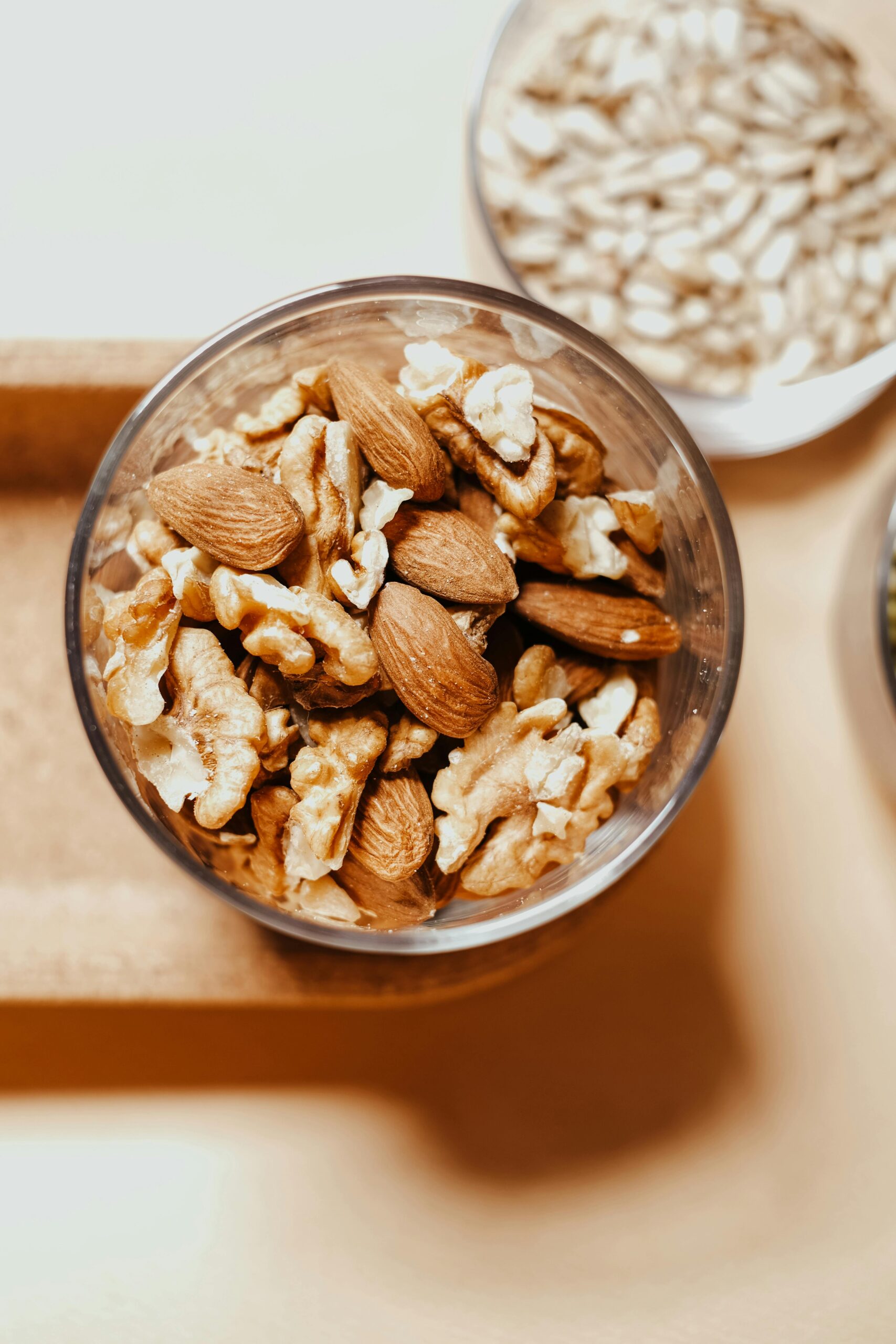 Glass bowl of nuts including almond and walnut