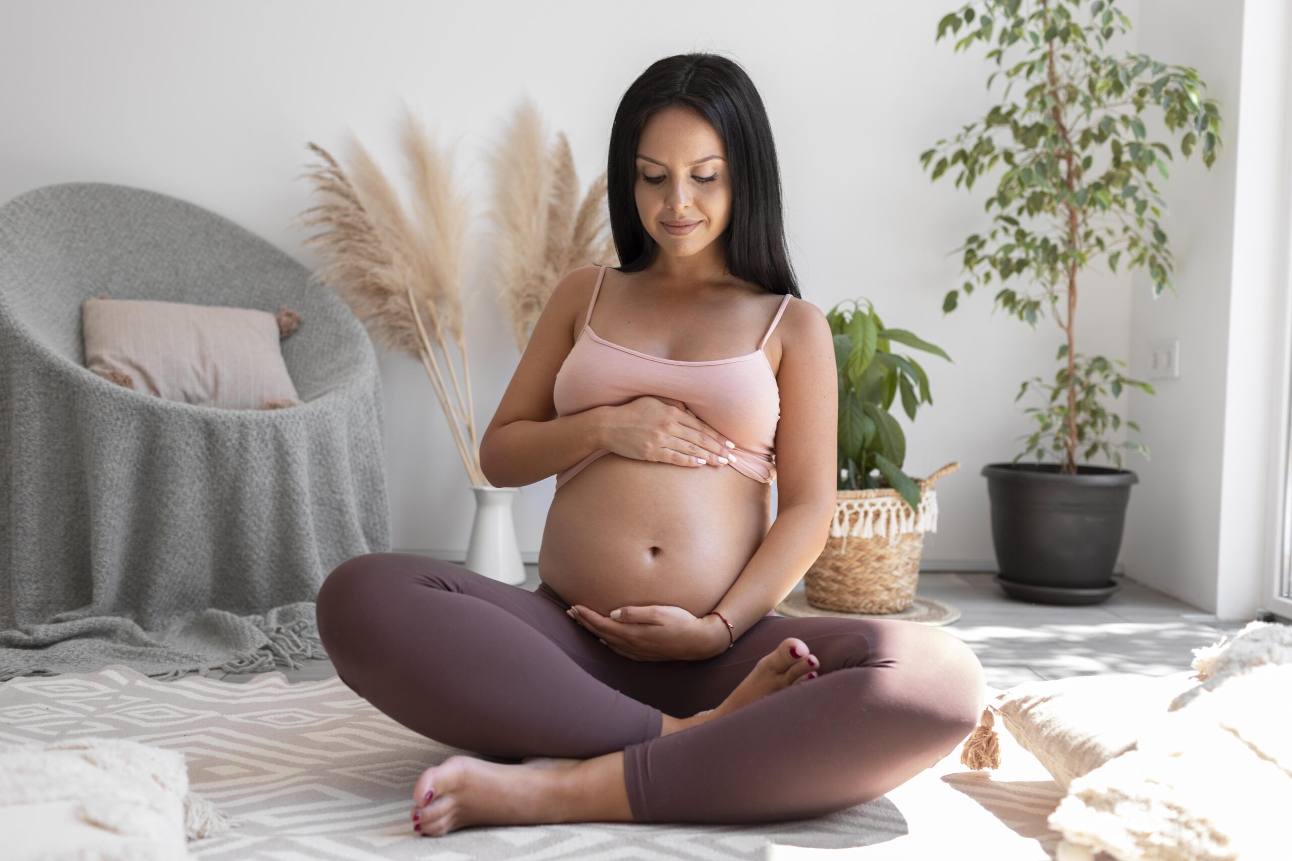 Woman holds her pregnant belly