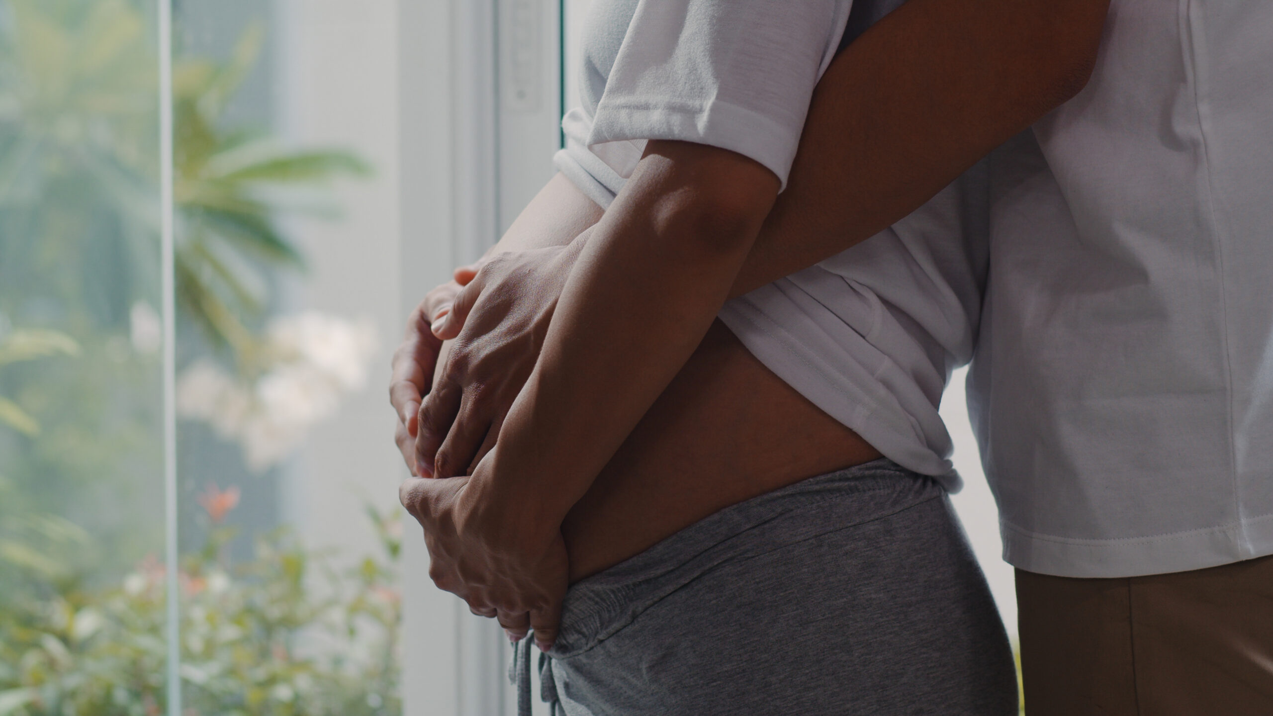 Pregnant couple cuddle