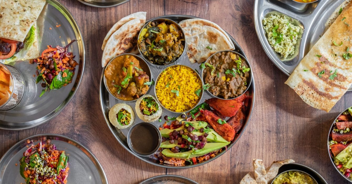 Vegan Indian dishes with rice and pittas on a table