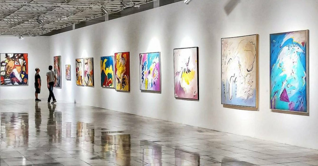 A showcase of the best of modern art paintings in a gallery.