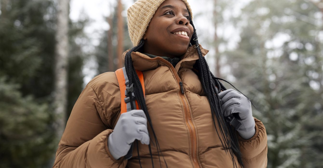 black woman hiking alone and smiling