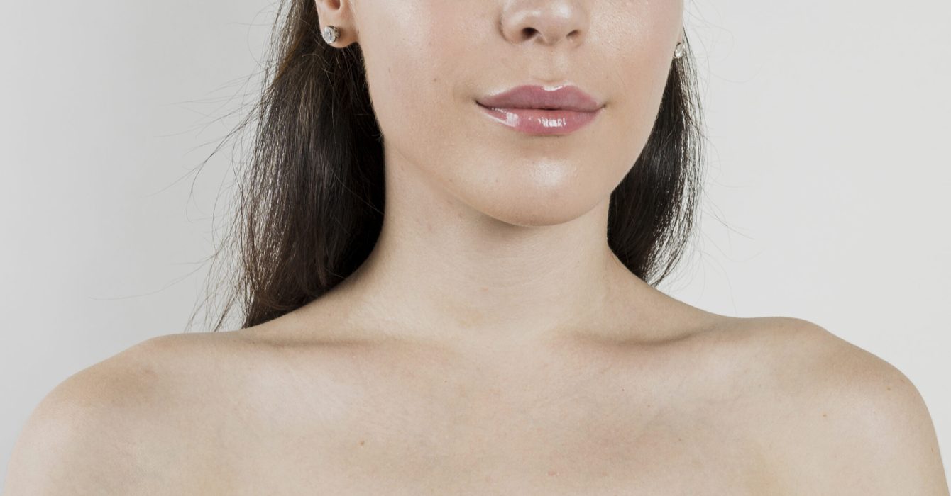 The bottom half of a woman's face showing a strong jawline