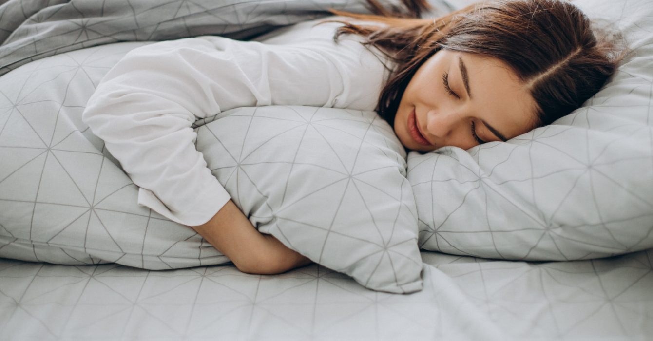 Young woman sleeping in her bed