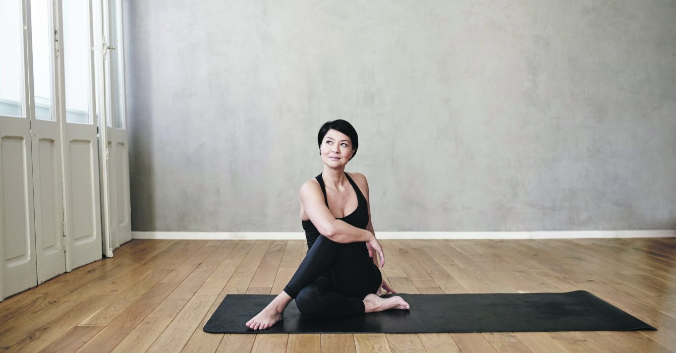 Woman practising yoga to relieve the symptoms of menopause