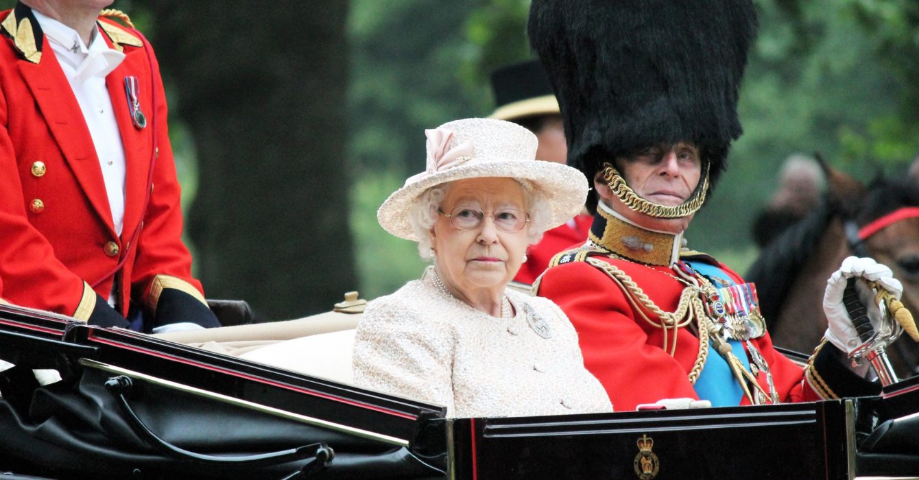 The Queen's guards escorting Queen Elizabeth II back to Buckingham Palace in her carriage.